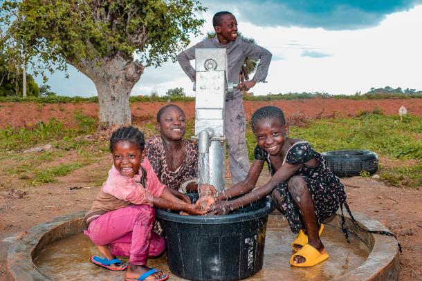 Children at a water pump providing groundwater