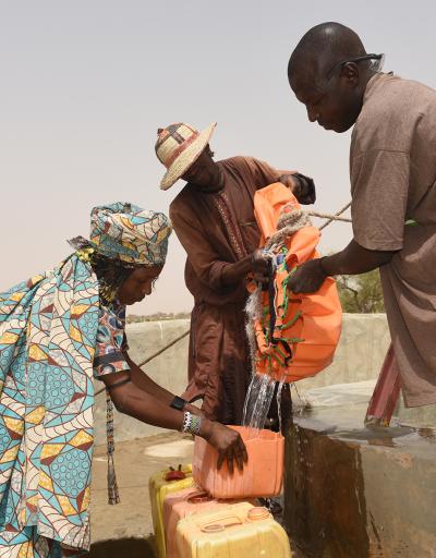 woman drawing water from a well, Lake Chad Basin