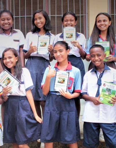 Schoolchildren proudly present the new textbooks they received as part of UNESCO’s cooperation in support of Basic Science Education in Timor-Leste