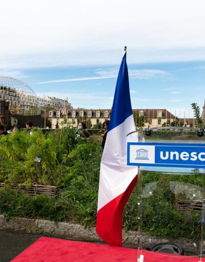 UN and French flags in UNESCO's urban garden at HQ in Paris, France
