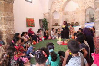 Children listening to a story in Al Khader Library, Gaza - after renovations