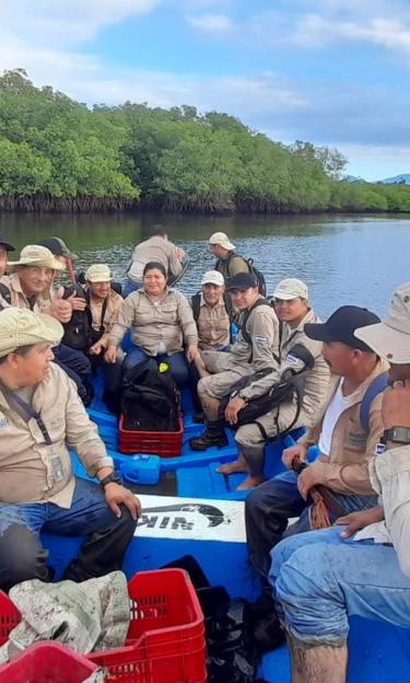 A team working on a reforestration project heads to a mangrove grove in the Xirihualtique-Jiquilisco Biosphere Reserve in El Salvador 