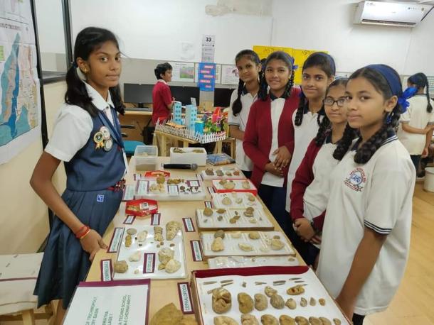 School student, Aswatha Biju, shows her fossil collection to other students
