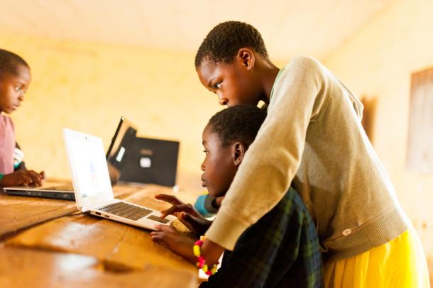 Cameroon school children learning to use computer in classroom 