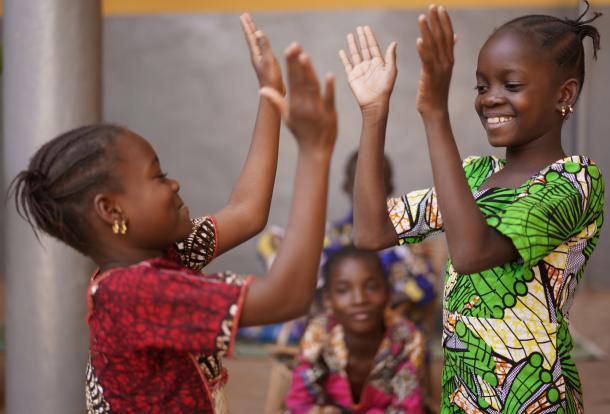 Two African girls hand clapping game