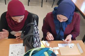 Two women in literacy course working on a puzzle